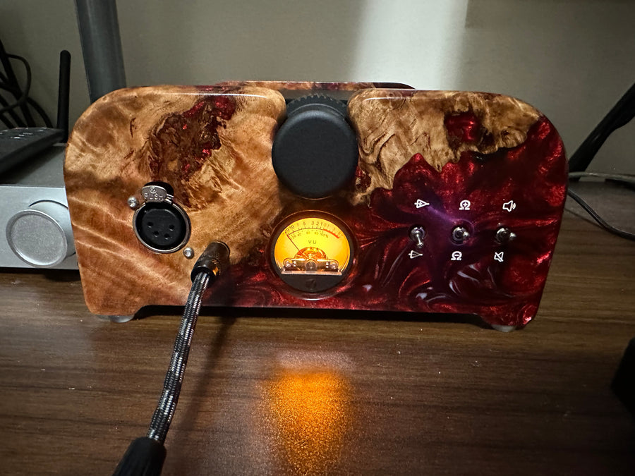 Wooden electronic device with a cable on a wooden surface