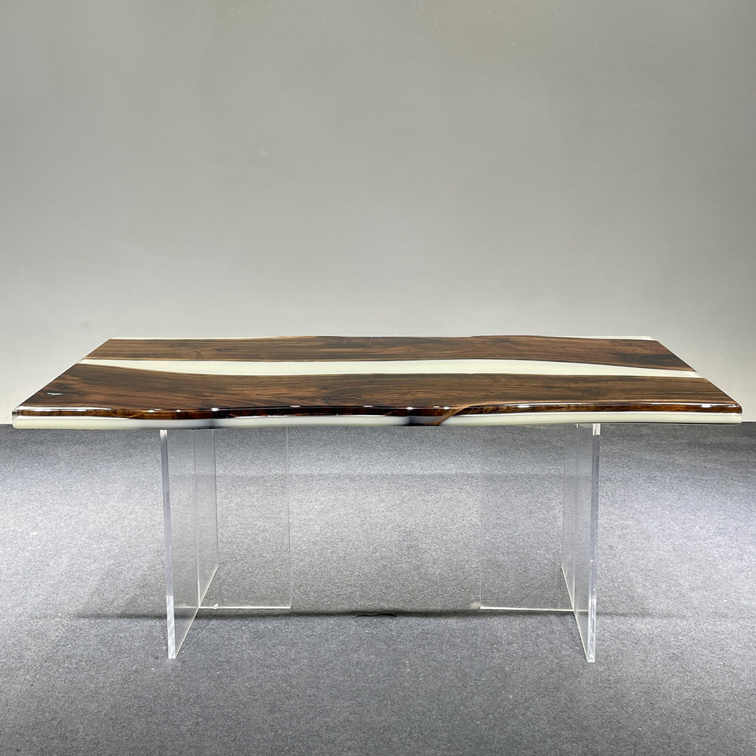 Wooden desk with clear legs on a gray floor and background