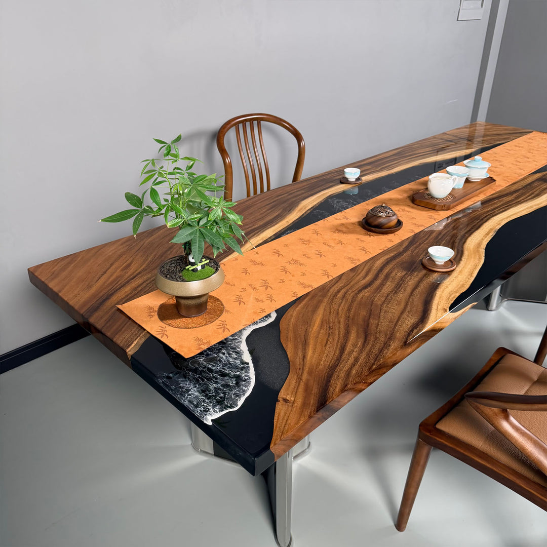 Detail of walnut table featuring black resin river with white wave effects