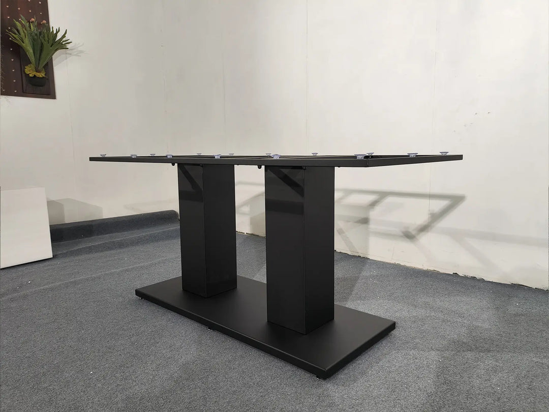 Angled view of the MTL14 black metal table base with twin pedestal supports and a rectangular floor plate