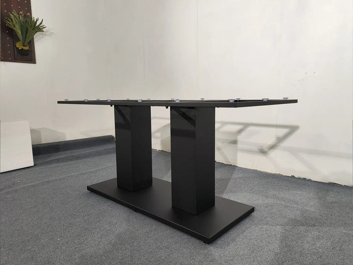 Angled view of the MTL14 black metal table base with twin pedestal supports and a rectangular floor plate