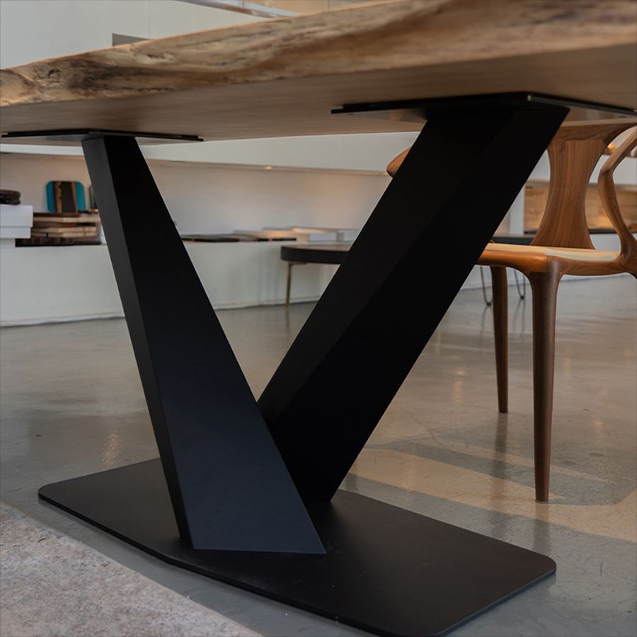 Side view of the MTL17 matte black metal table base featuring an architectural X-shaped support and rectangular floor plate