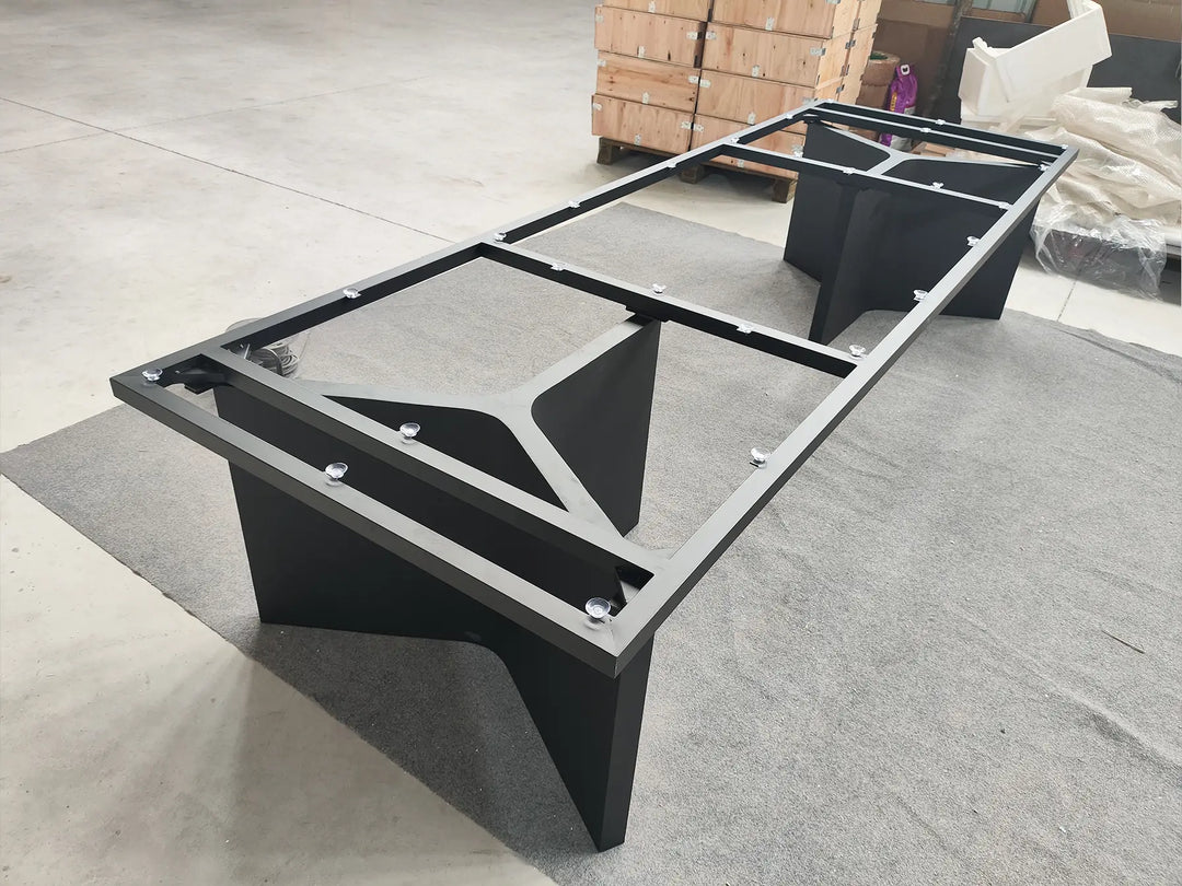 Angled view of the MTL22 double trapezoid metal table base showing the pedestal structure and upper support frame