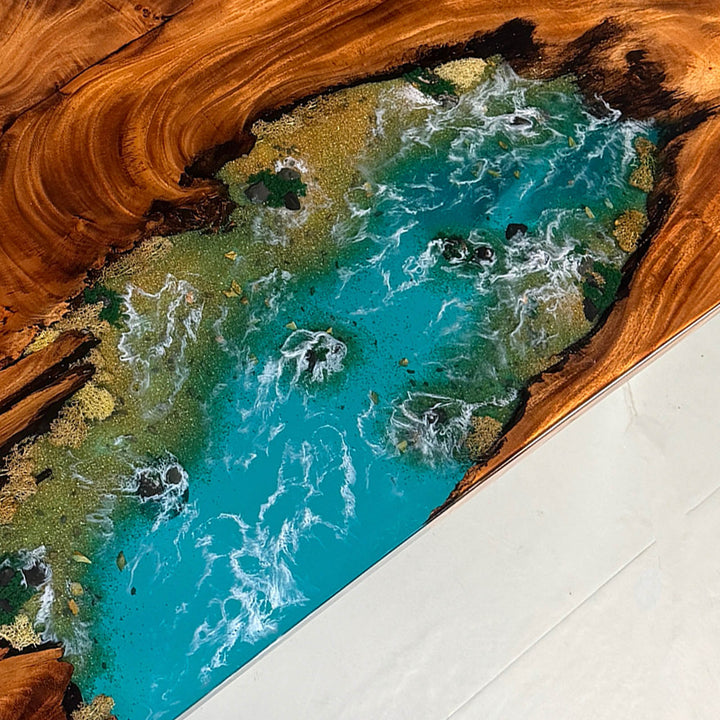 Artistic flow of ocean blue resin river contrasting with natural walnut wood grain