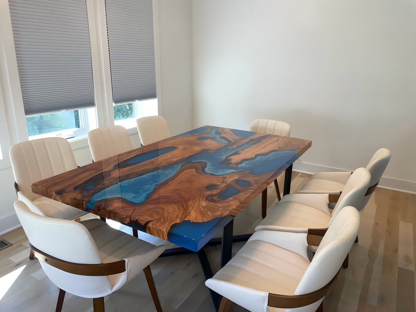 Olive wood epoxy resin dining table featuring a solid blue opaque resin base with a clear resin top, straight edges, and a glossy polished surface — custom handmade live edge table by Seawave Table