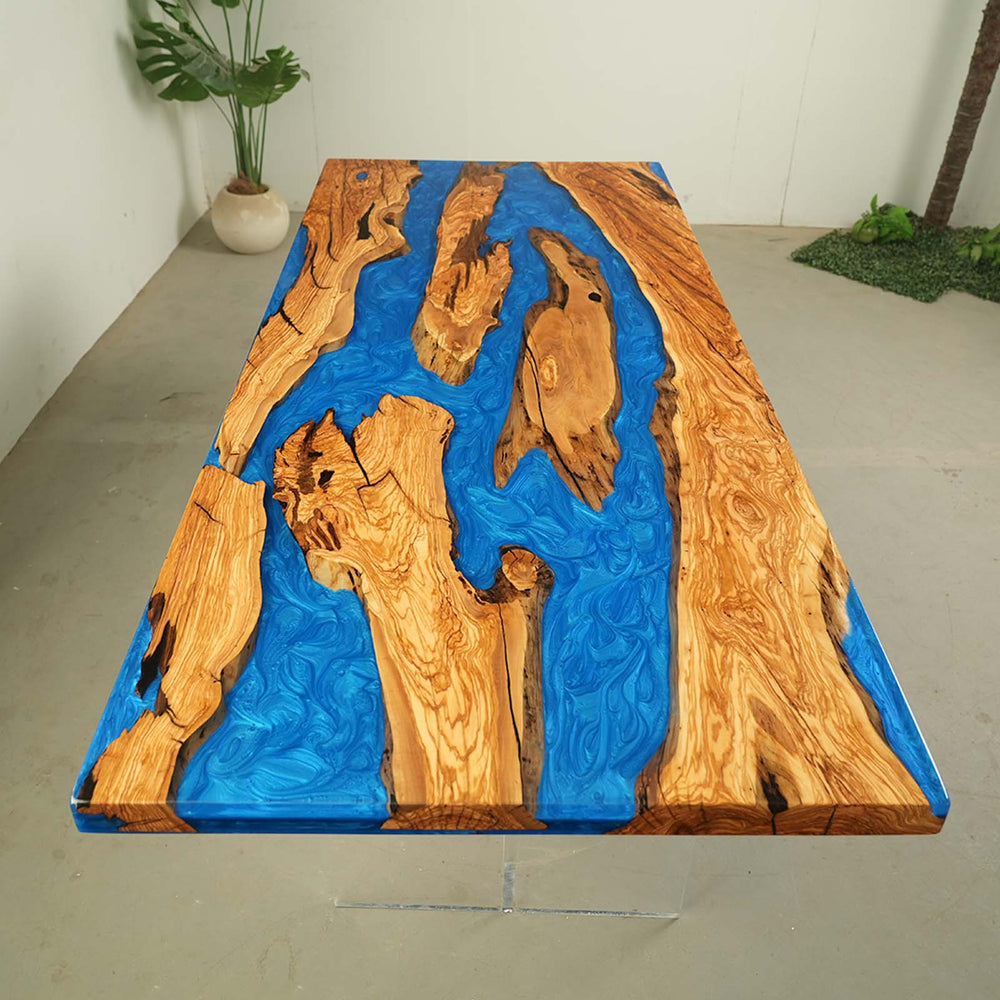 Close-up of premium olive wood grain with crystal blue epoxy river and high-gloss finish