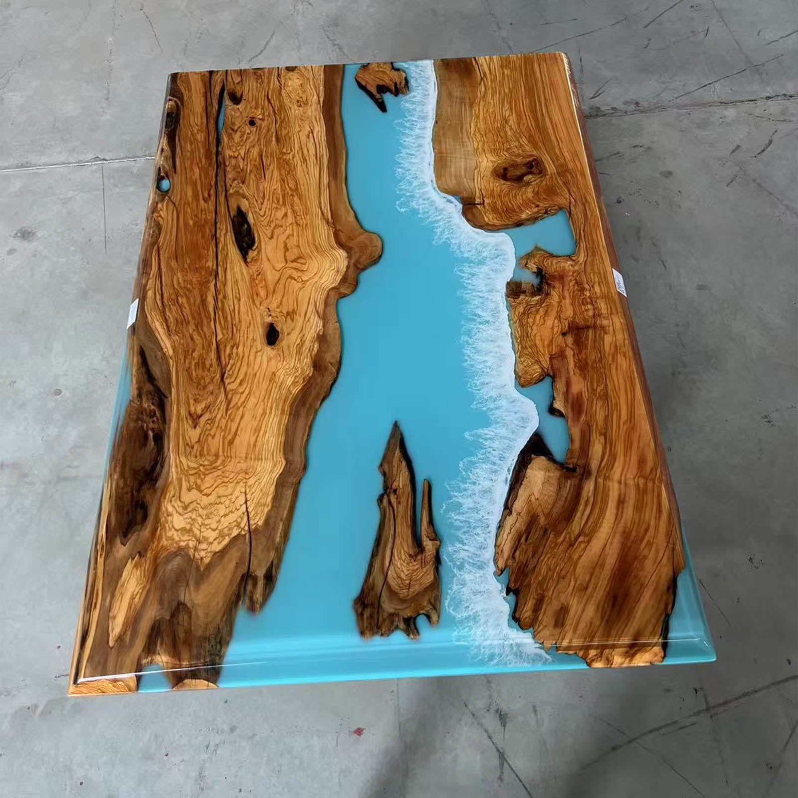 Detail view of Mystic Lagoon epoxy resin patterns highlighting the olive wood’s natural curves.