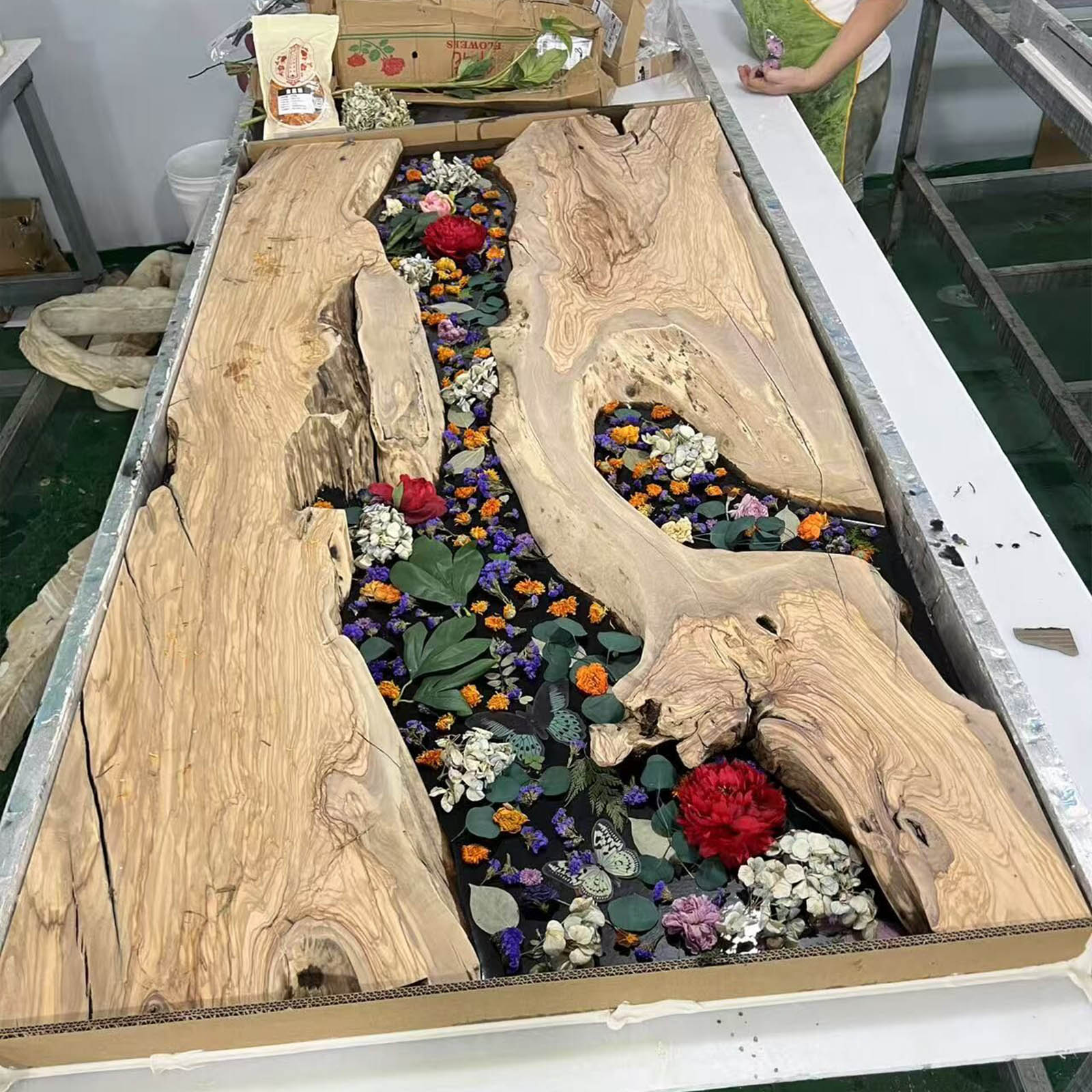 Leg and base view of CRT-213 olive wood river table with black epoxy.