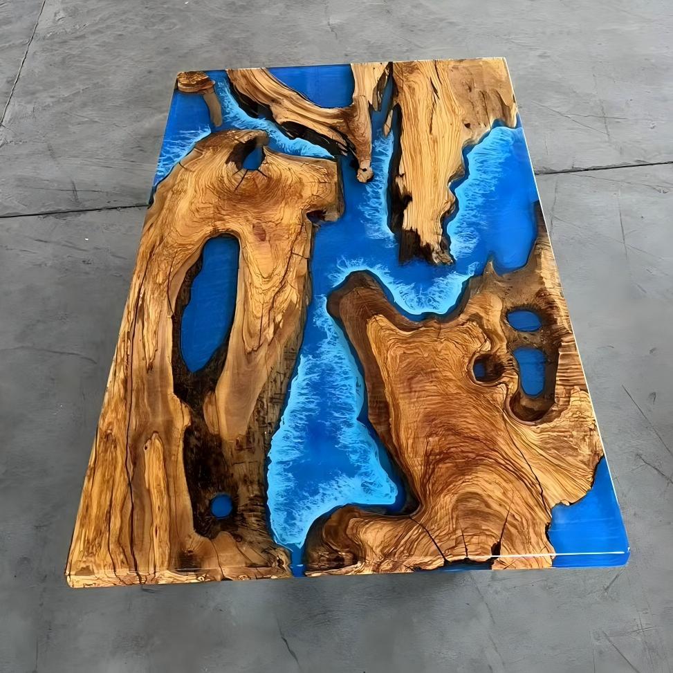 Olive wood table with swirling ocean blue opaque resin base and transparent epoxy top