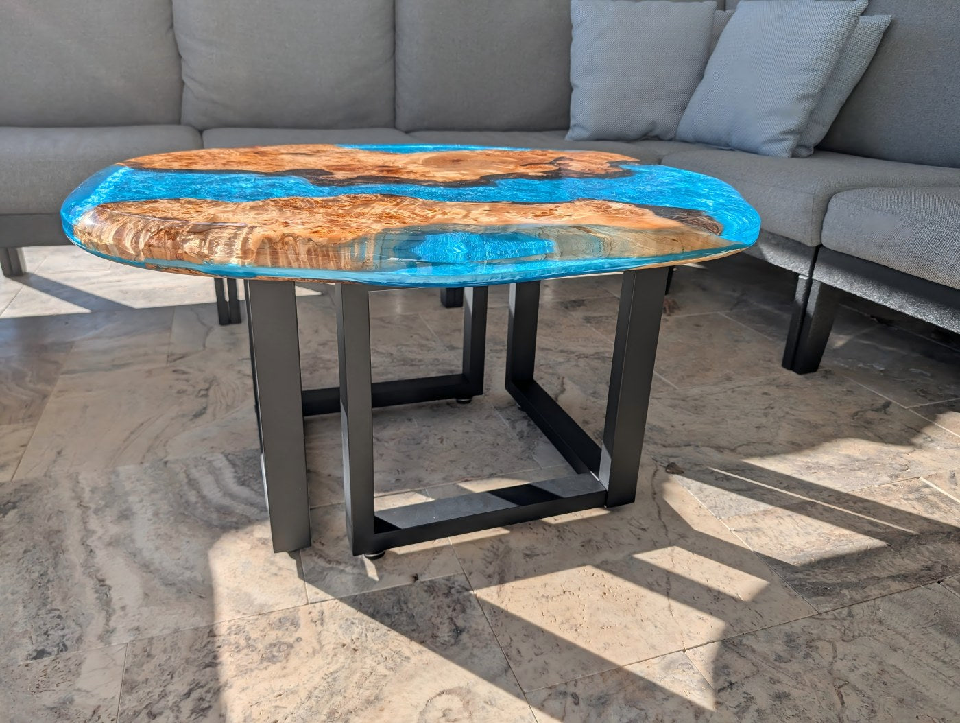 Finished poplar and blue resin table installed in backyard pavilion.