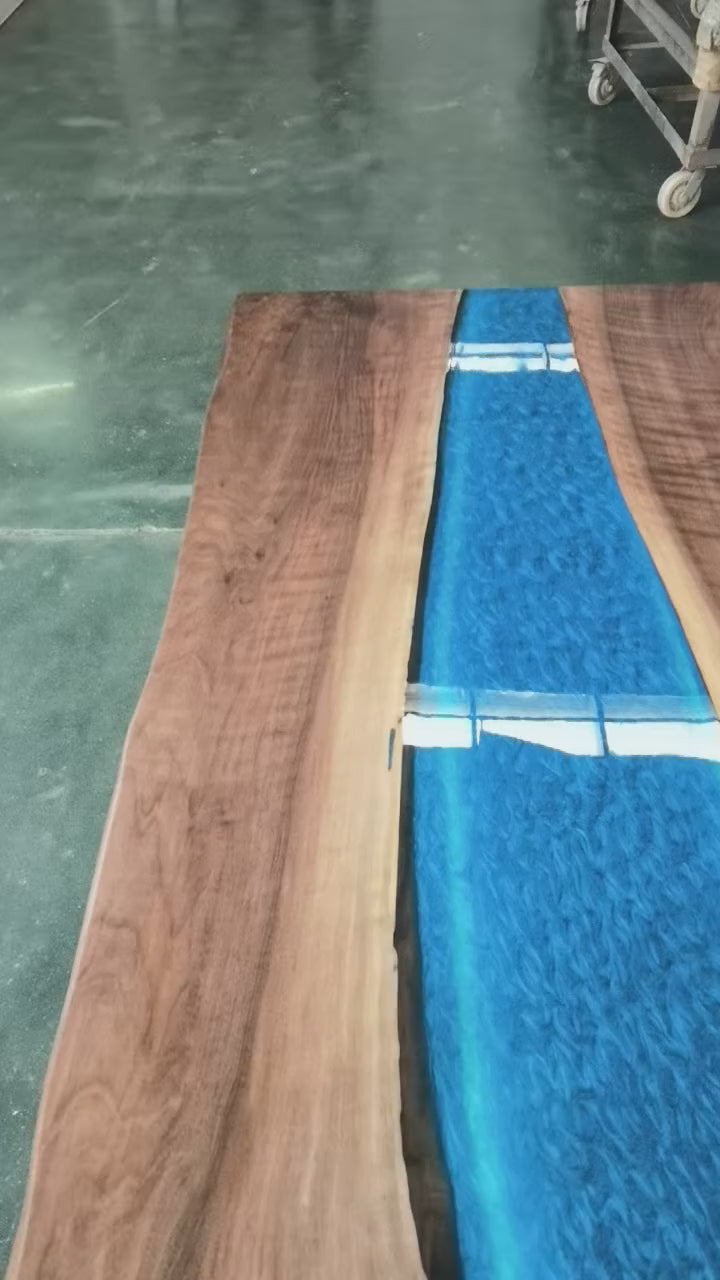 Artisan made epoxy resin river table with glowing LED resin feature