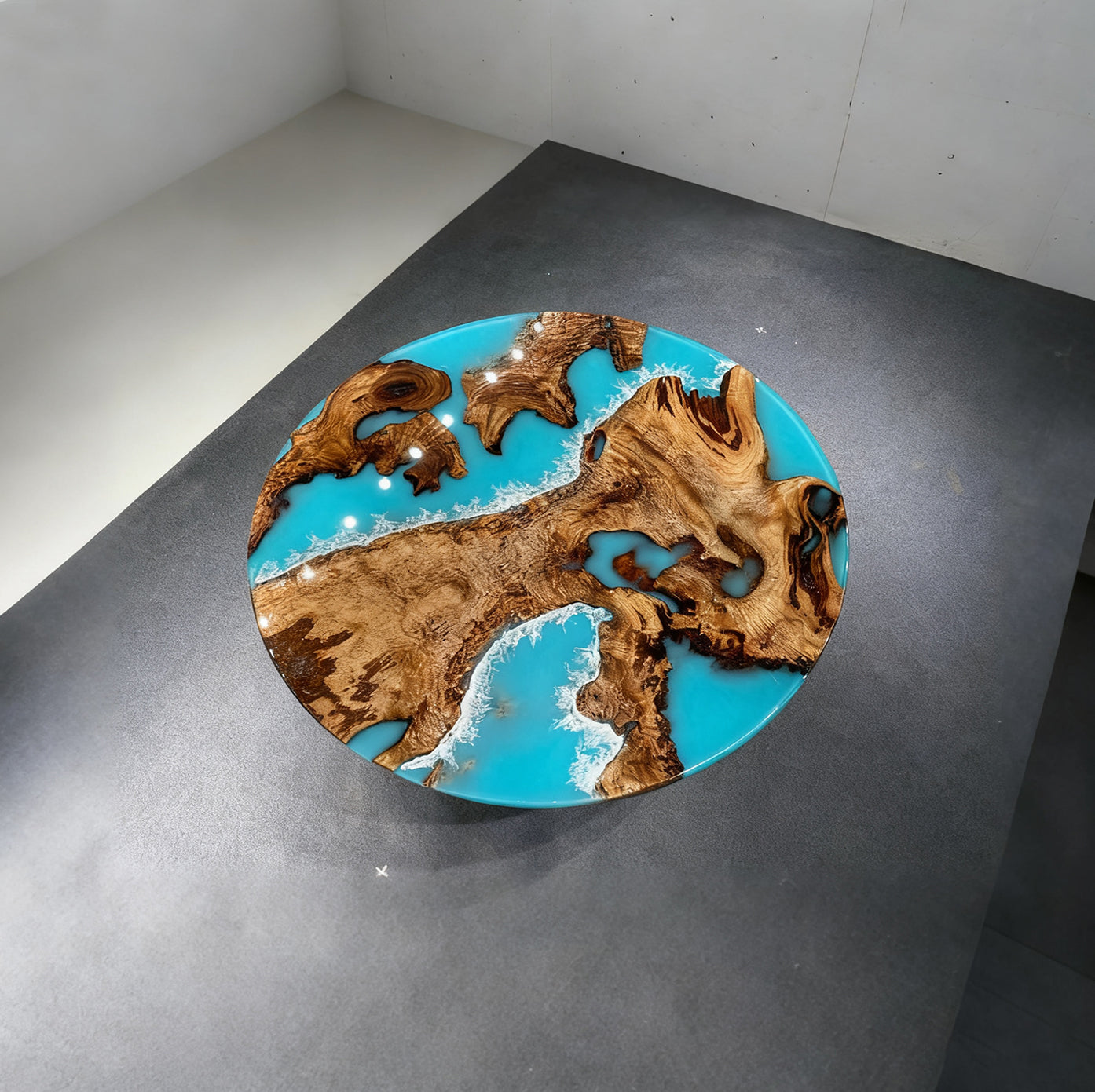 Finished round dining table made of golden camphor wood with ocean blue resin