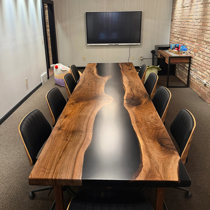 SeawaveTable black walnut black epoxy conference table in industrial meeting room with multimedia screen in Sturgis MI