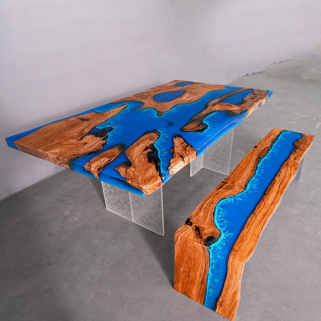 SeawaveTable olive wood epoxy river table angle view showing blue wave effect and natural grain