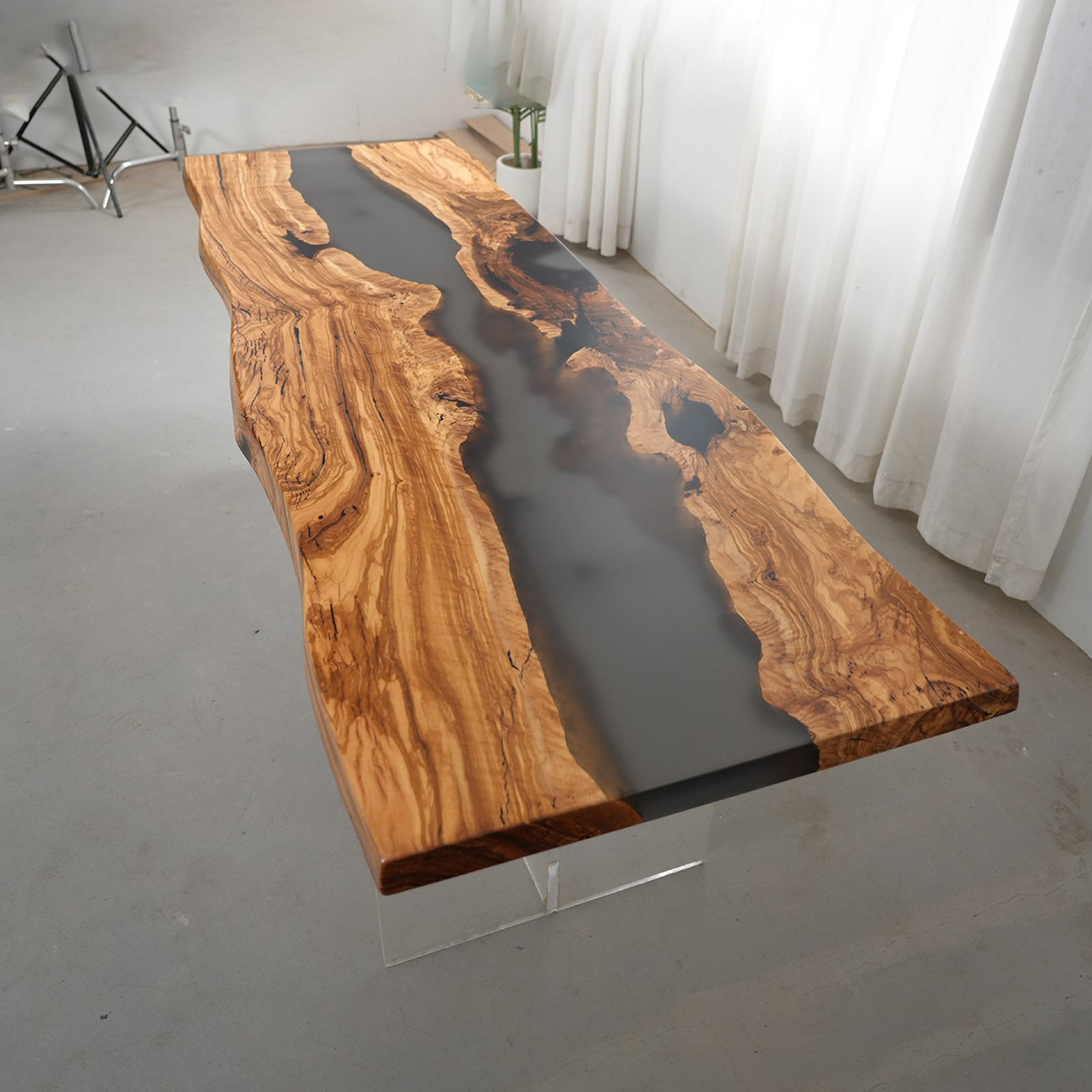 Pouring matte Smoky Quartz resin into olive wood table for Shannon’s pavilion.