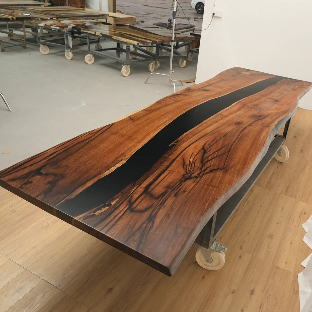 Solid black epoxy river detail on Black Walnut table