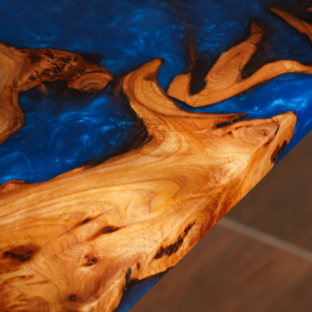 Wooden surface with blue resin flow, close-up view
