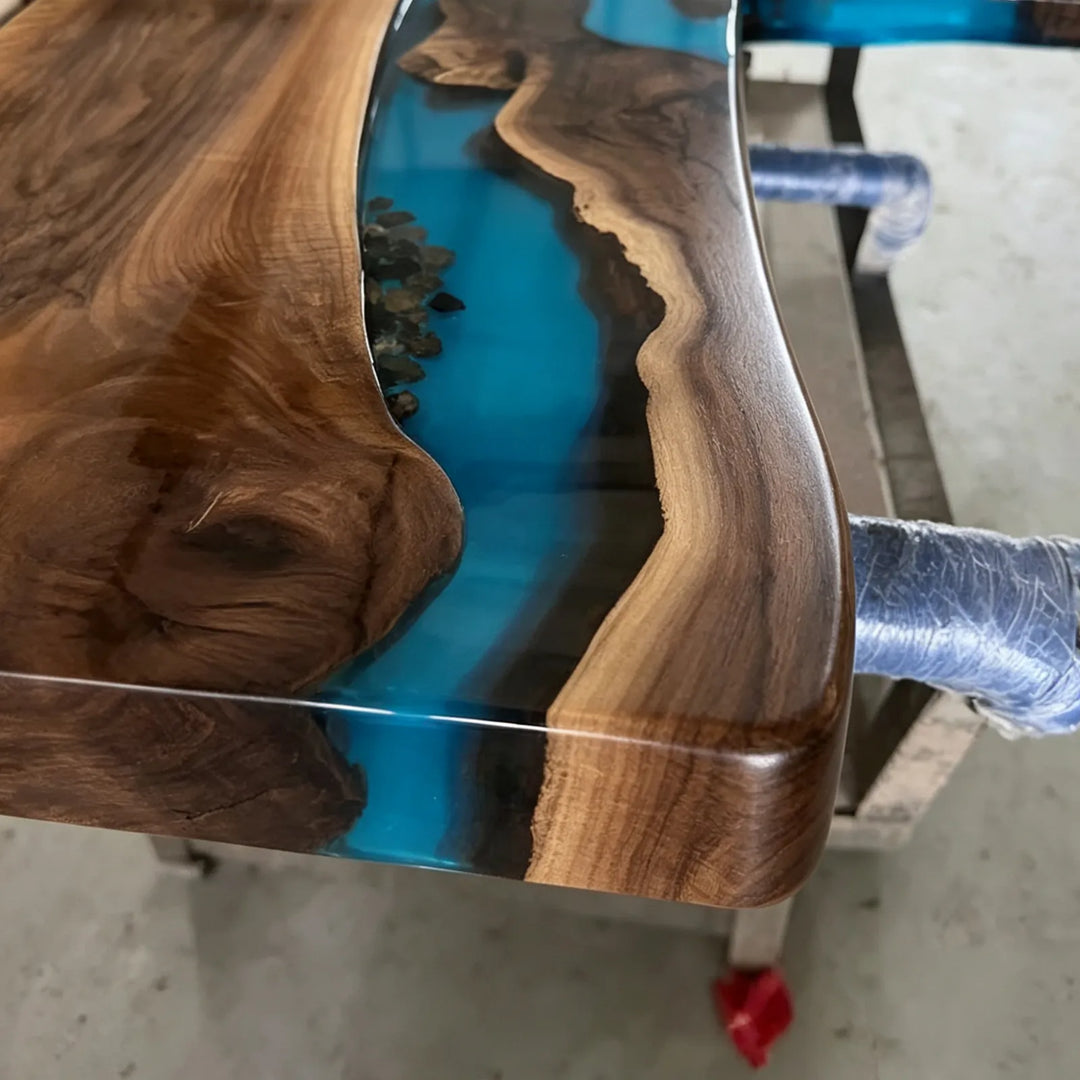 Translucent blue epoxy and natural stone detail on Black Walnut desk