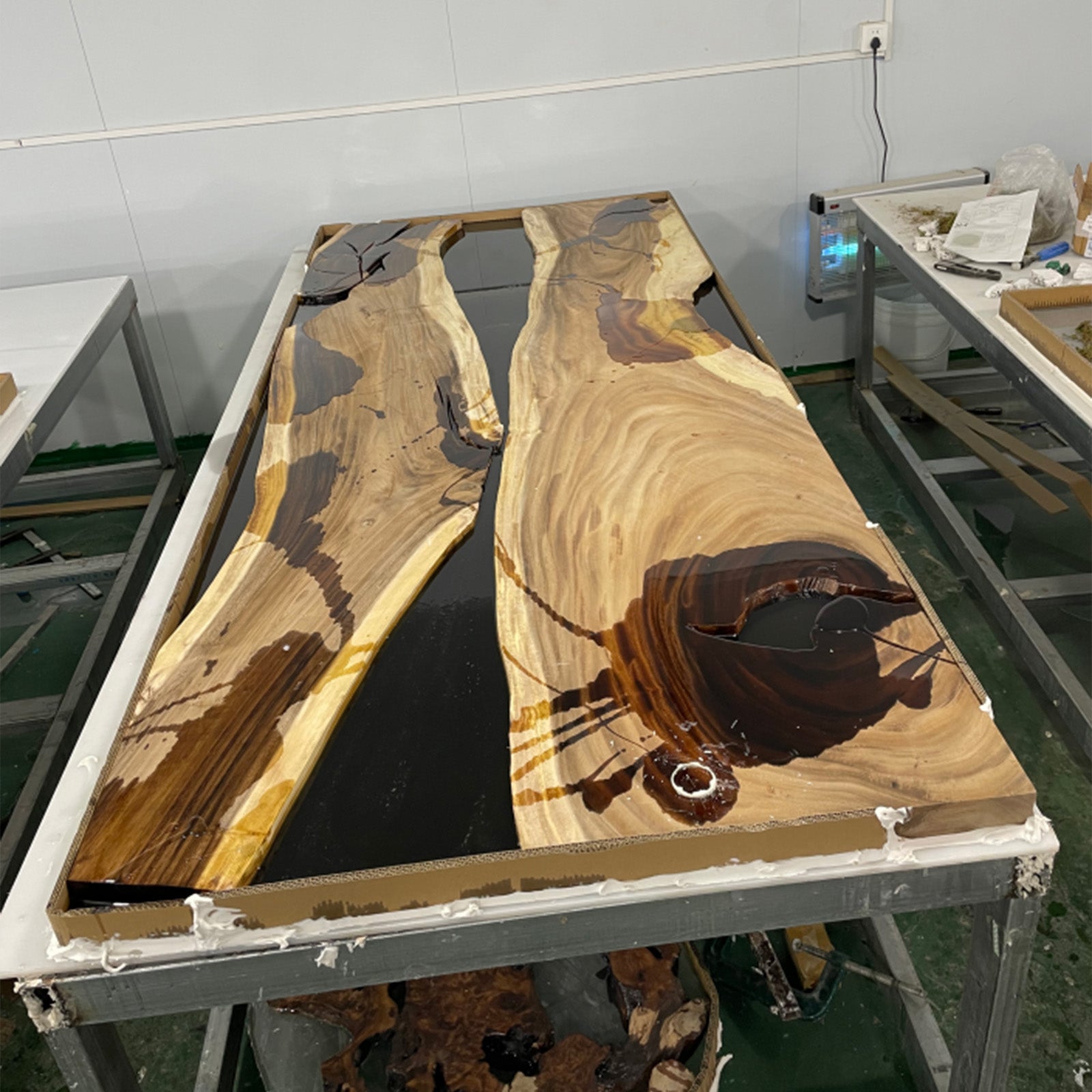 Close-up showing black epoxy resin flow and natural walnut grain with contrasting white sapwood.