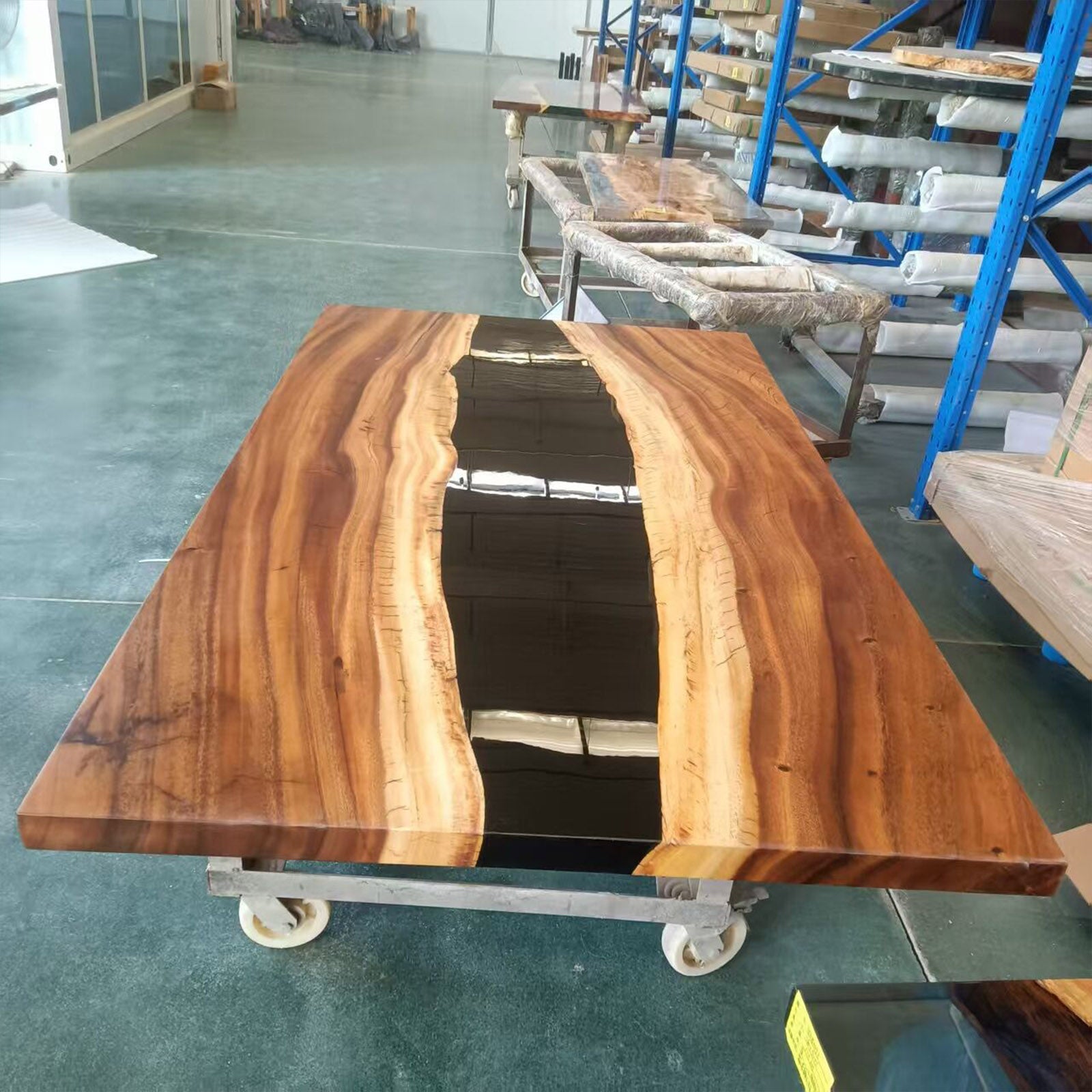 Top view of straight-edge walnut rectangular table featuring a clean black epoxy river.