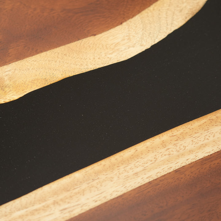 Side profile of live-edge walnut table with black epoxy