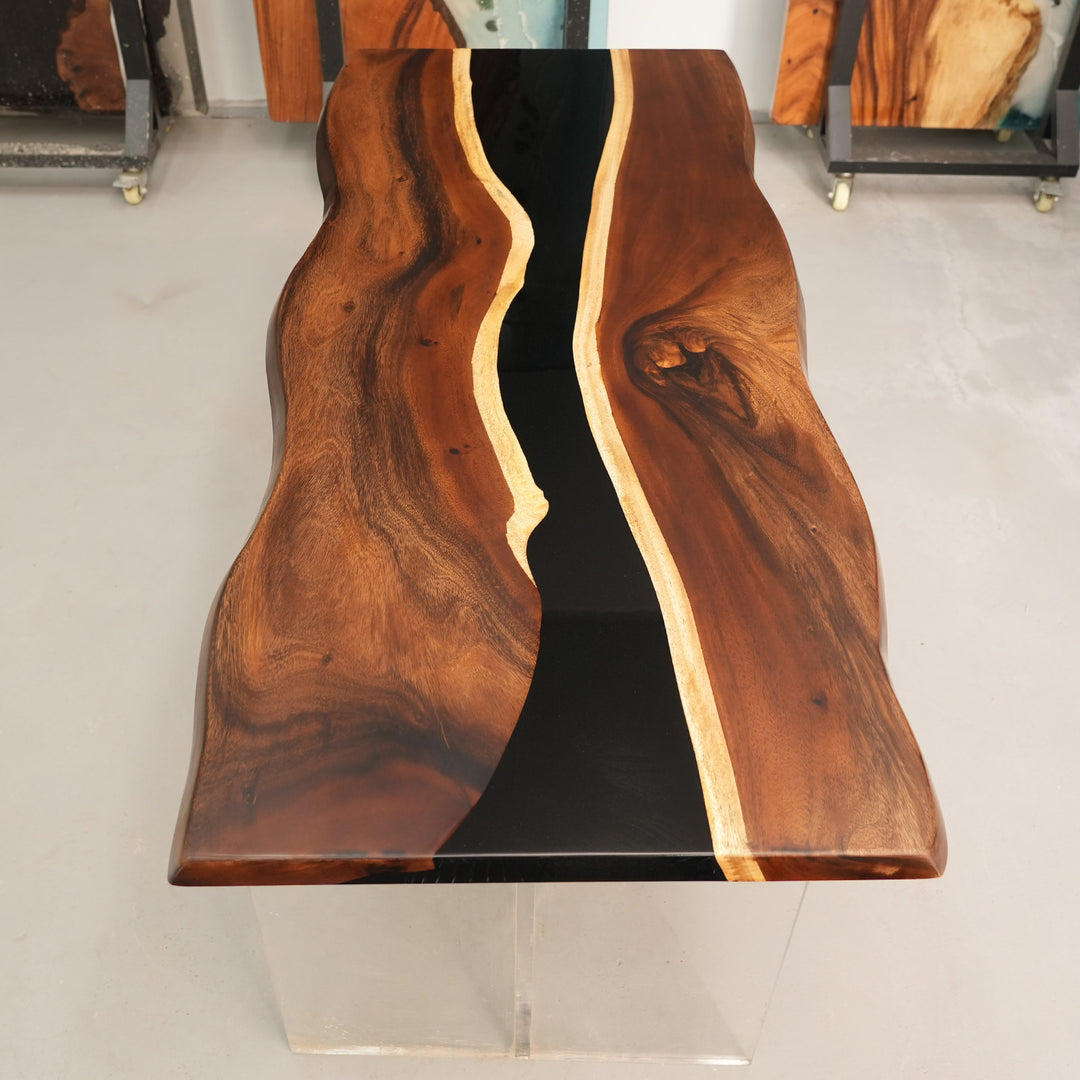 Walnut river table with glossy black resin and matte wood surface