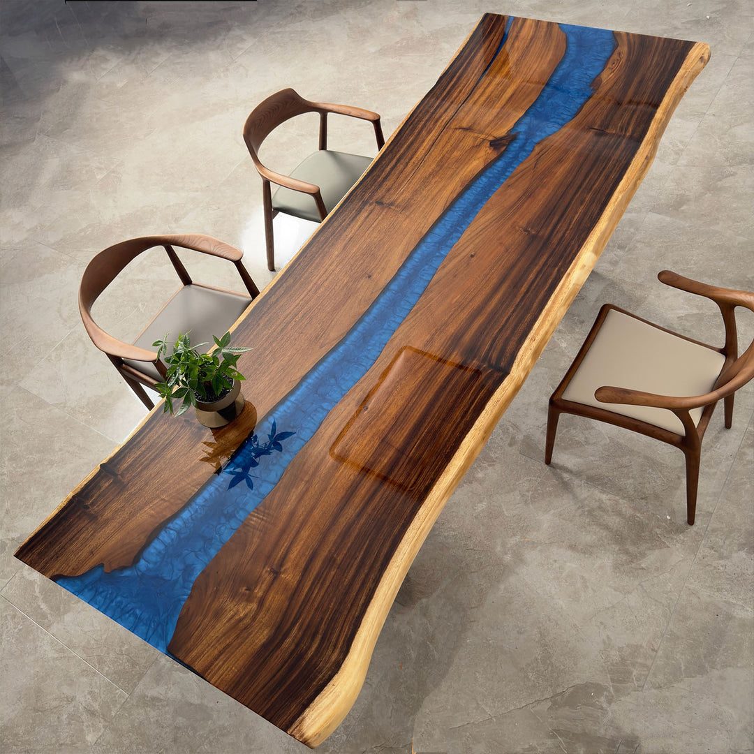 Top view of walnut epoxy river dining table in navy blue resin