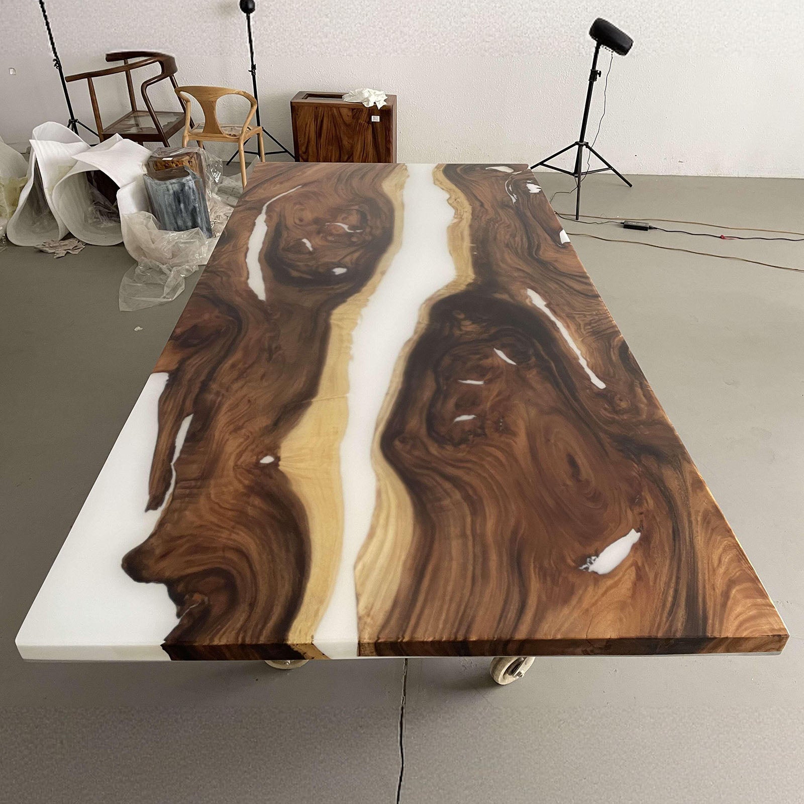 Rectangular walnut dining table with white epoxy center, modern handcrafted home design.