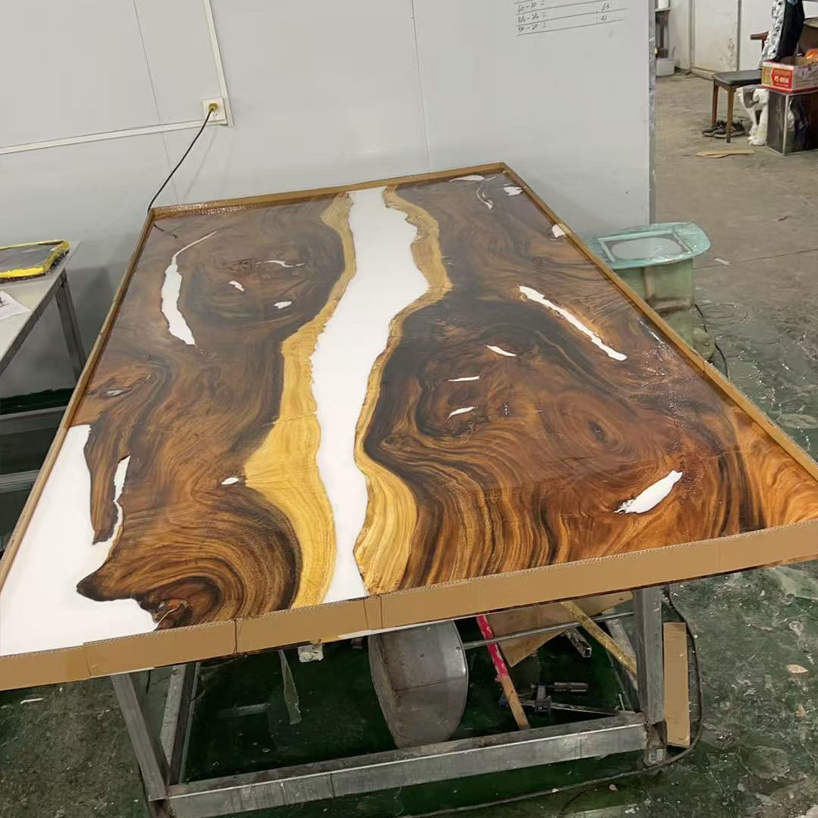 Side view of walnut and white epoxy table with smooth glossy finish.