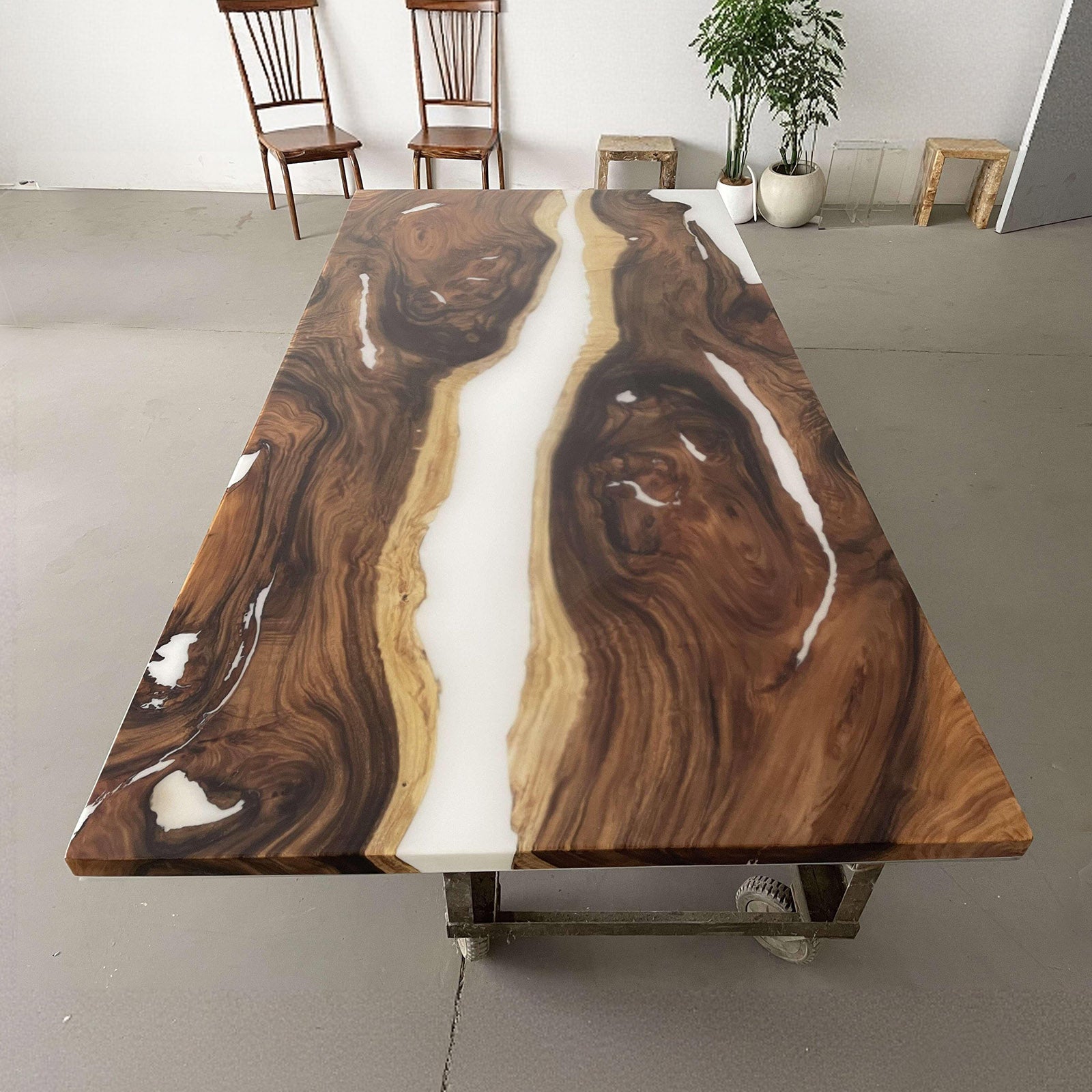 Detailed view of white resin flowing through walnut wood grain, handcrafted solid wood table.