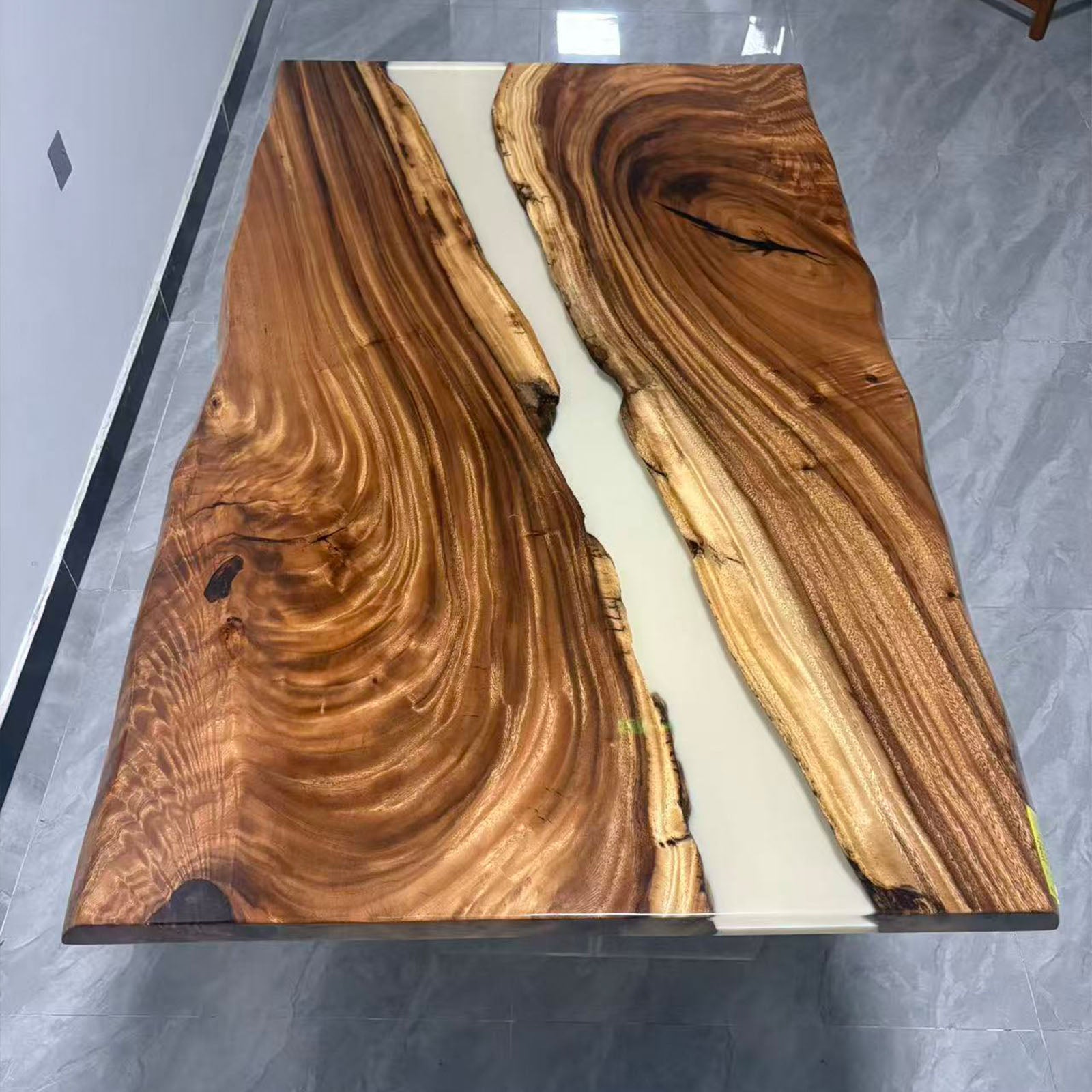 Close-up showing natural walnut grain and elegant white resin pattern