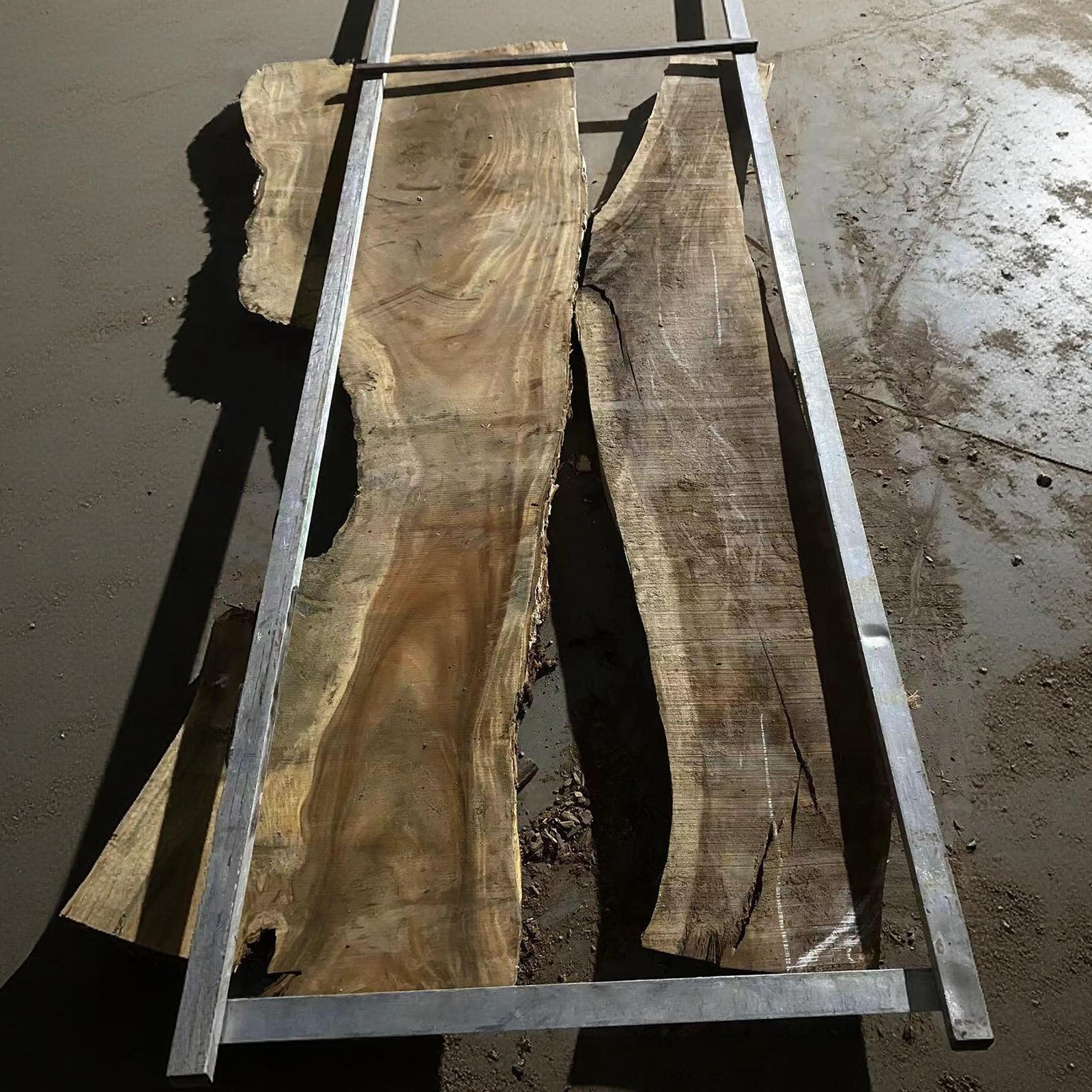 Handmade walnut dining table with white sapwood edges and black epoxy river, solid wood craftsmanship.